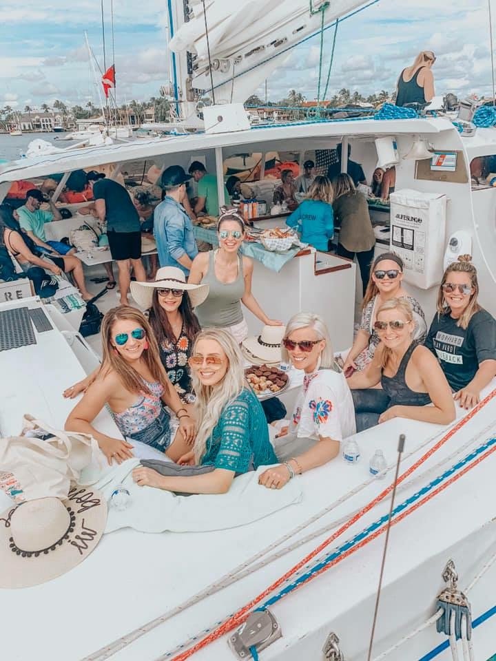 Team relaxing on a catamaran in the tropics
